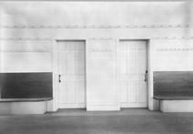 SA0451b - Photo shows two doors, one for Shake sisters and the other for brothers; also, wall benches and pegs. Identified on the back., Winterthur Shaker Photograph and Post Card Collection 1851 to 1921c